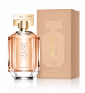 Hugo Boss The Scent For Her perfume bottle with a gold cap next to its beige packaging box, on a white background with a soft reflection.